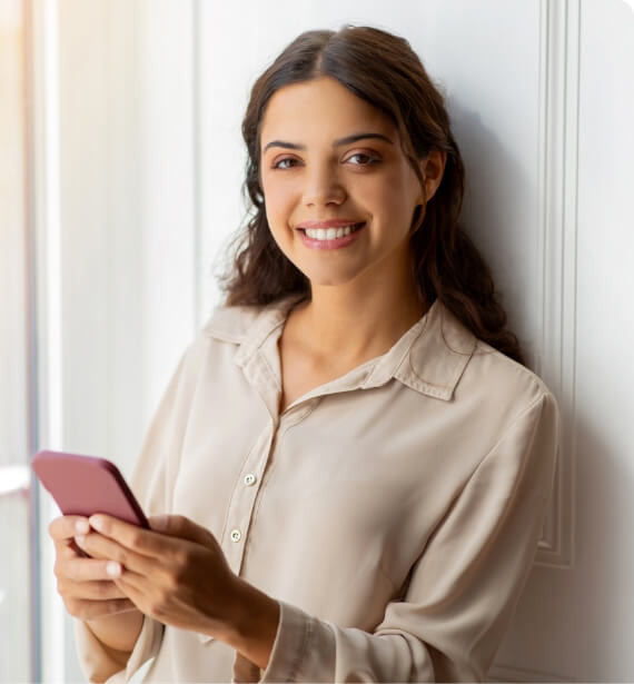 happy-young-woman-holding-smartphone-and-smiling-w-2024-03-25-23-33-29-utc (1)